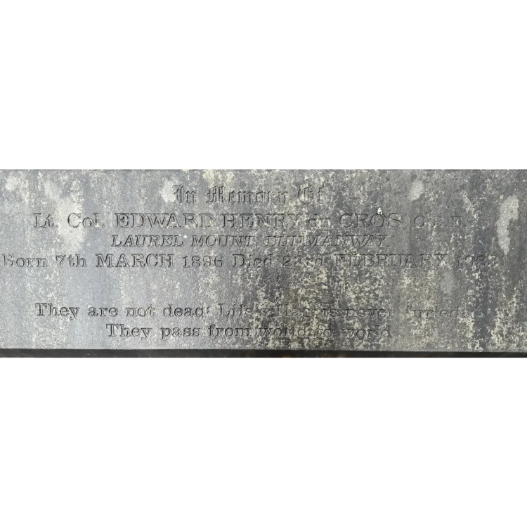 A close-up photograph of a rectangular grey stone grave marker with an inscription. The carved text reads: "In Memory Of Lt. Col. EDWARD HENRY du CROS O.B.E. LAUREL MOUNT, DUNMANWAY Born 7th MARCH 1896 Died 23rd FEBRUARY 1983. They are not dead: Life's flag is never furled: They pass from world to world". The stone shows mottling and weathering from age.